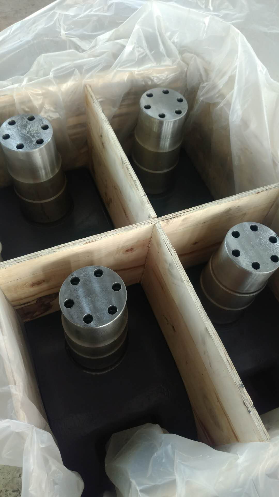 Machined alloy steel components in wooden crate